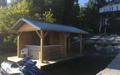 Boat house with bar by dock