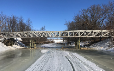 Bridge over frozen river under construction