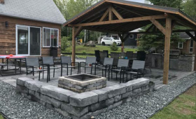 Covered outdoor kitchen area with BBQ fire pit