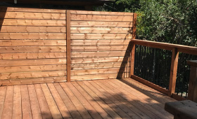 Wood deck with a privacy wall and railing