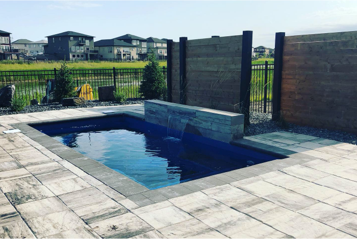 Stone pool deck and bright blue pool